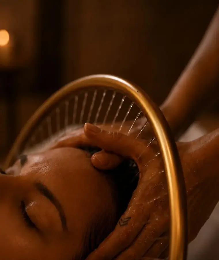 Mains massant le cuir chevelu sous l'arche d'eau du head spa
